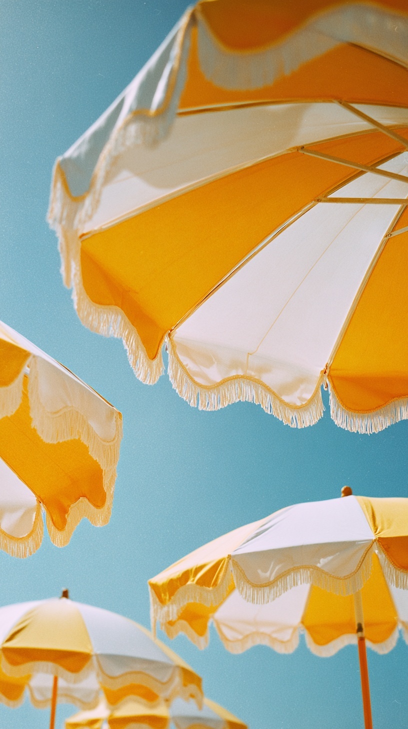 Chic Vintage Beach Umbrellas Under Sunset Skies
