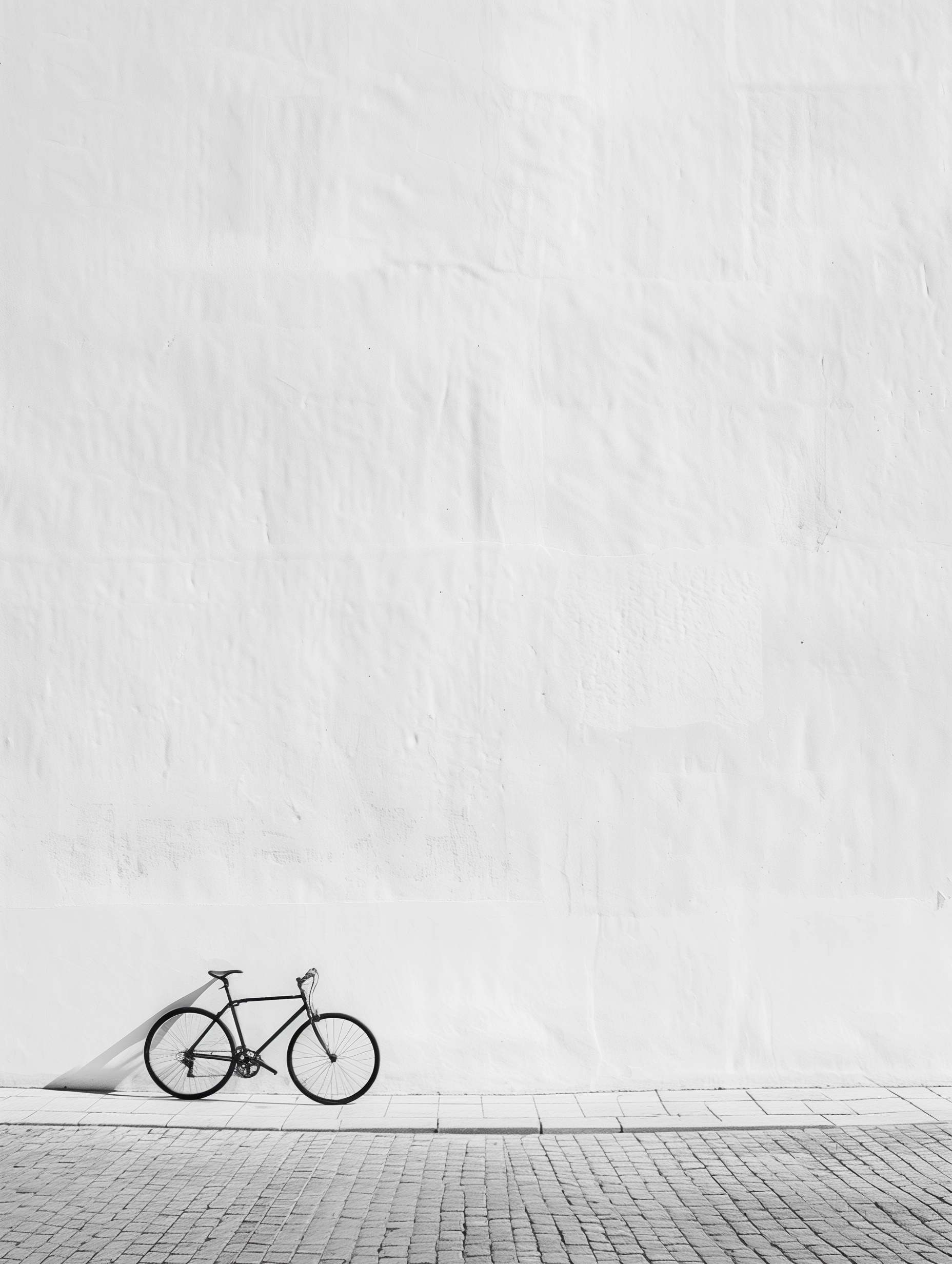 Urban Minimalism: Lone Bicycle Against Stark White Wall