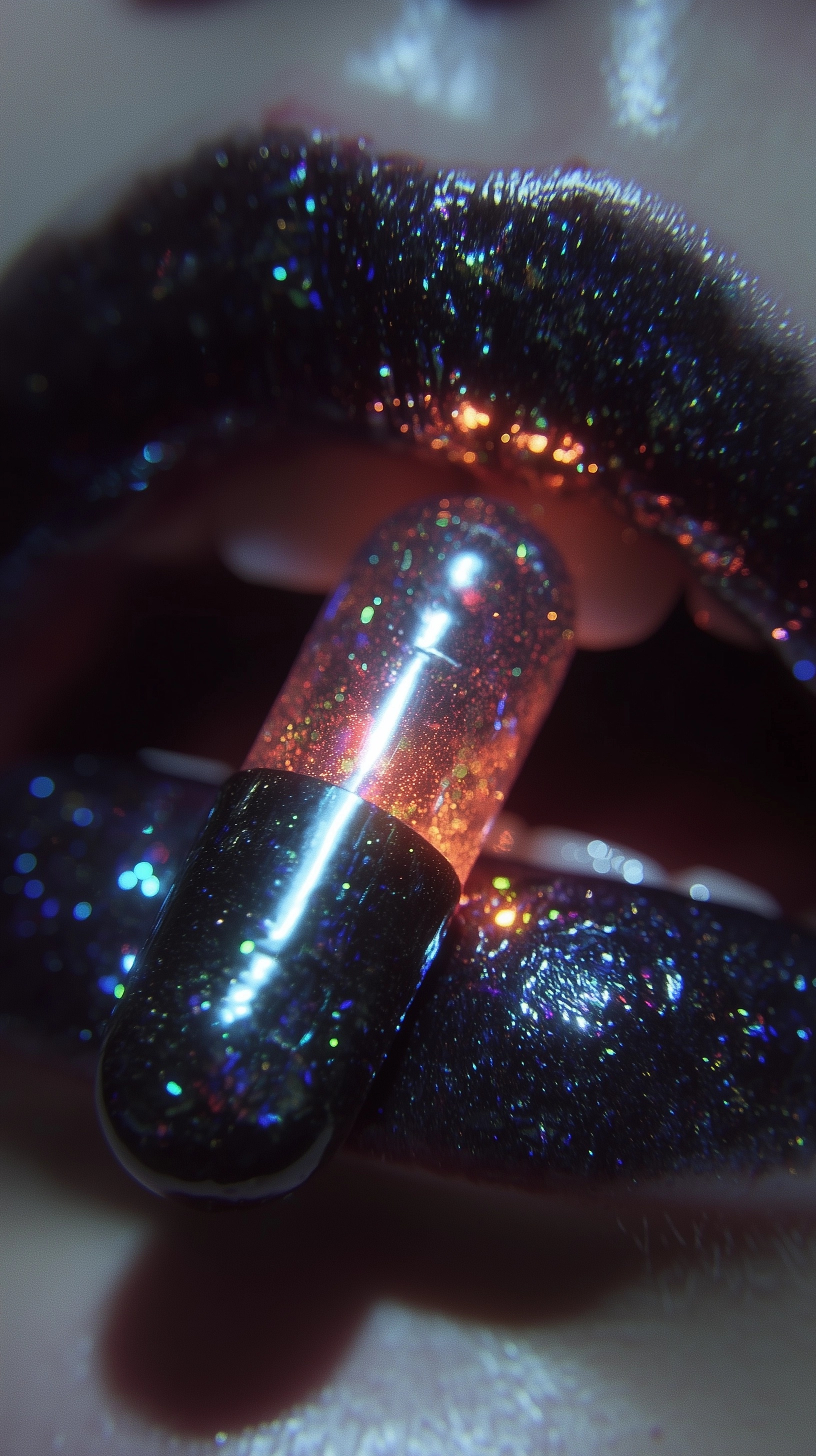 Iridescent Black Lips with Shiny Pill Close-Up