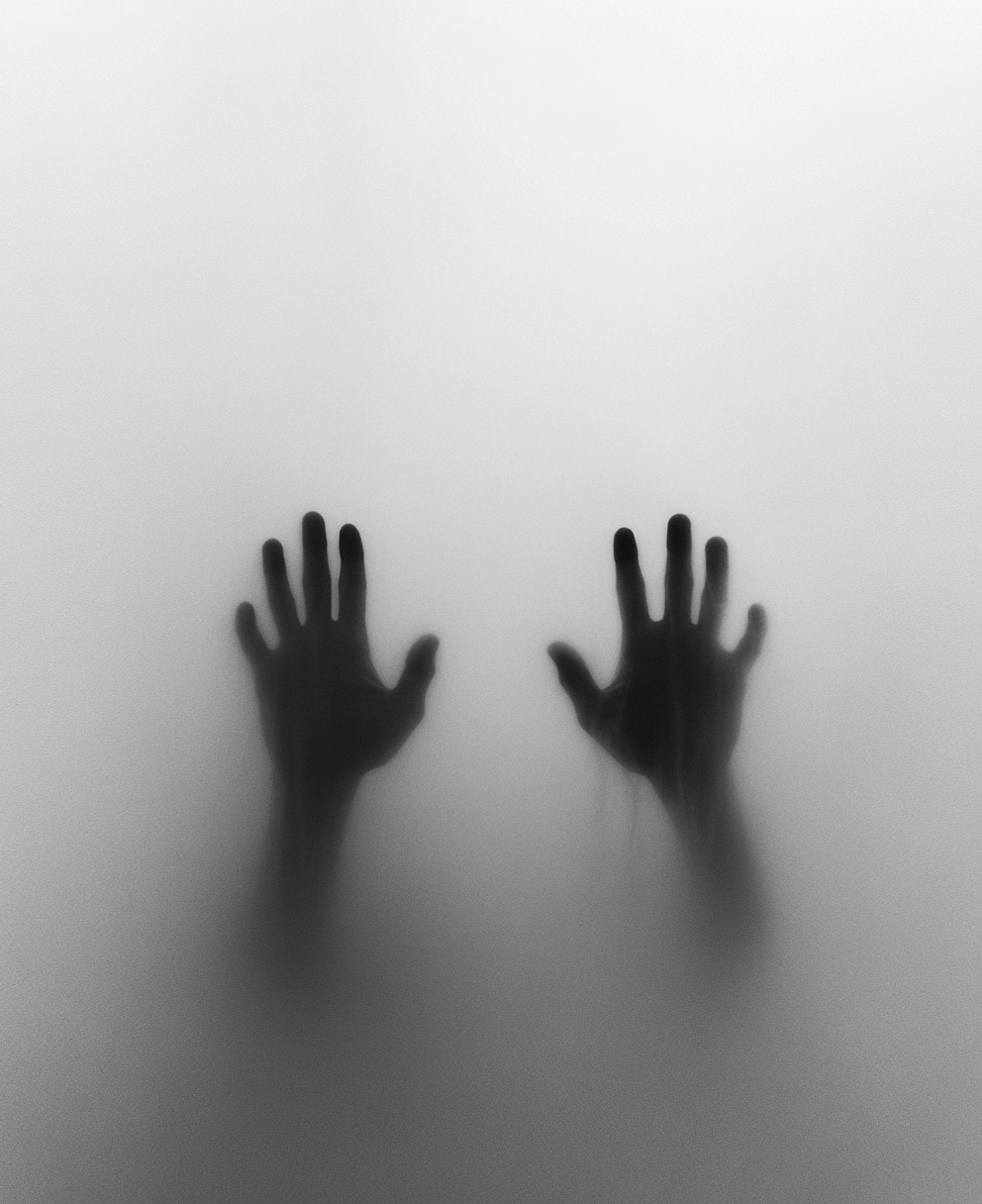 Unseen Secrets: Hands Behind Foggy Glass