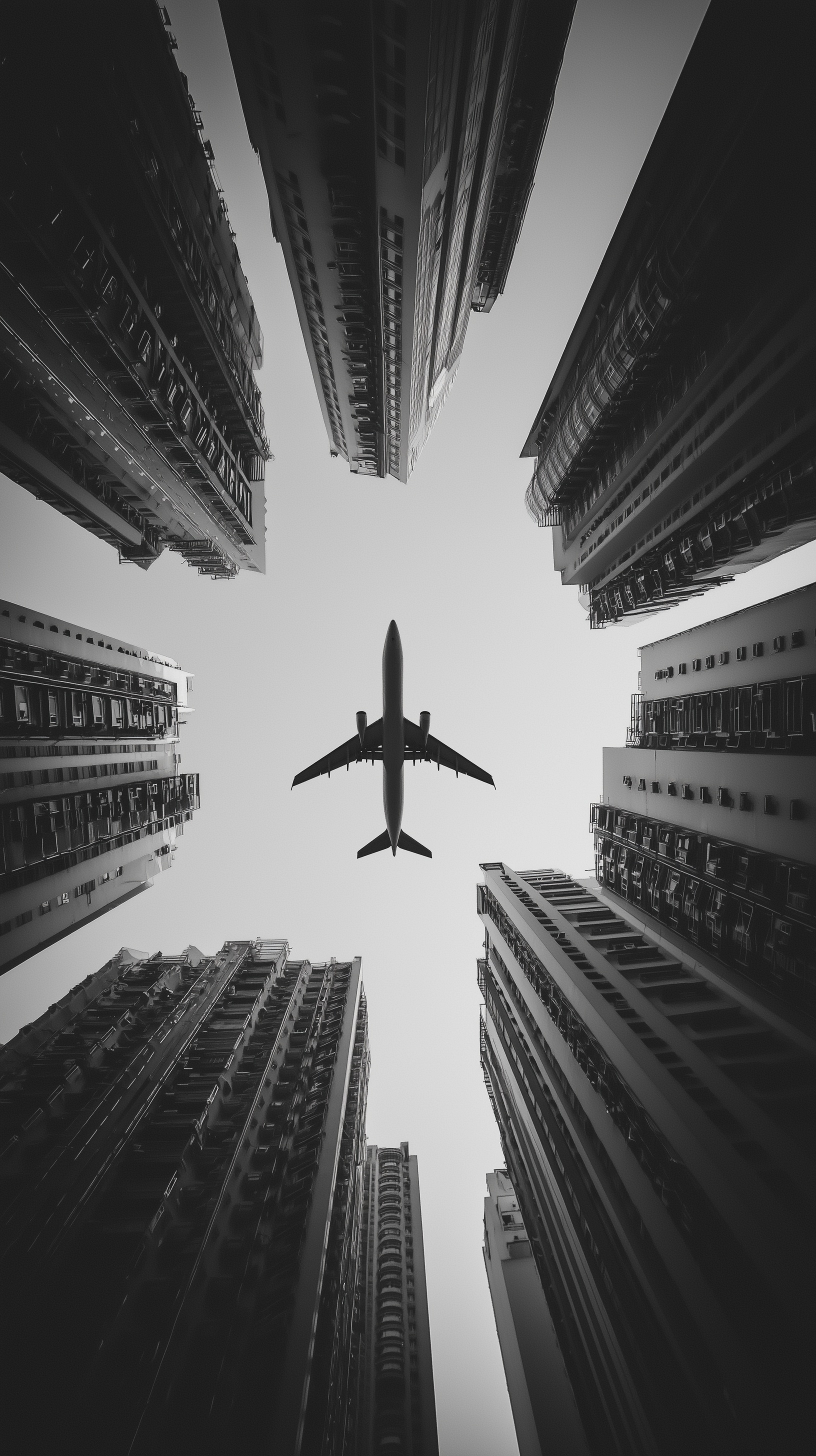 High-Flying Views: Airplane Amidst Towering Skyscrapers